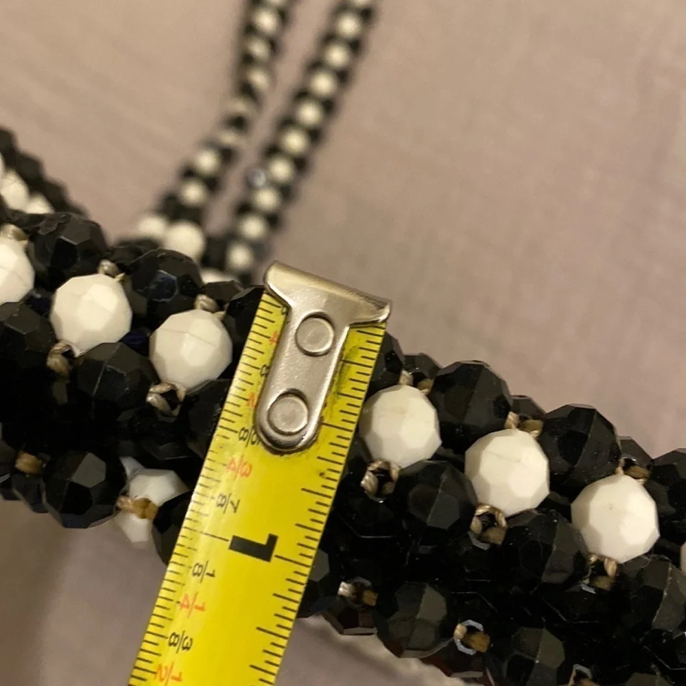 Black and white beaded shoulder beautiful bag .